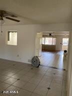 empty room featuring tile patterned flooring and ceiling fan