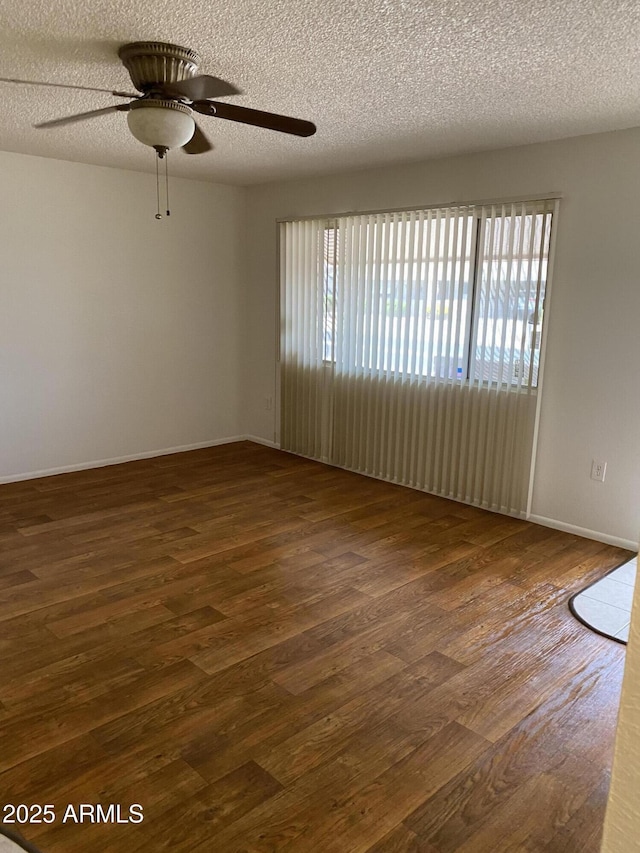 spare room featuring a textured ceiling, ceiling fan, and wood finished floors