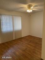 empty room featuring a ceiling fan and wood finished floors