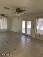 spare room with french doors, radiator, and ceiling fan