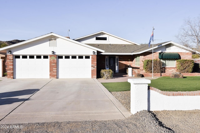 ranch-style house with a garage and a front yard