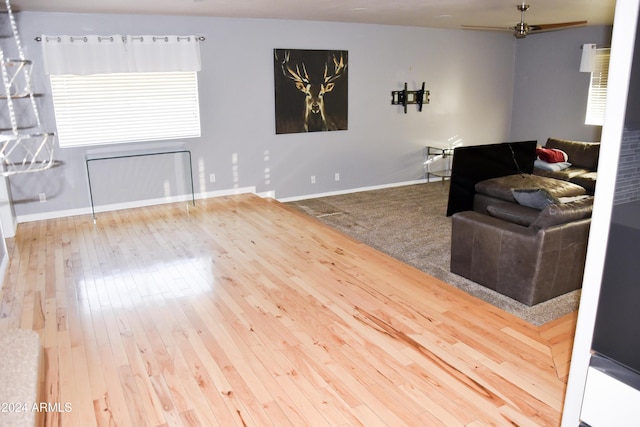 living room with hardwood / wood-style floors and ceiling fan