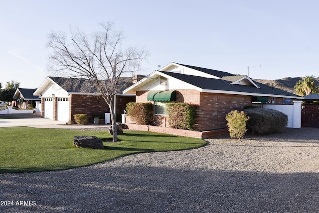 ranch-style house with a garage and a front yard