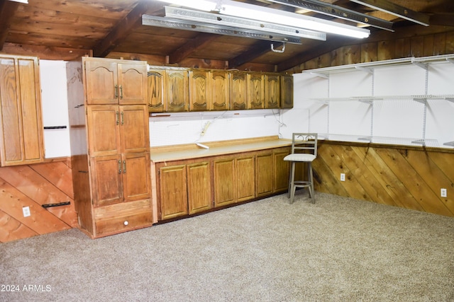 kitchen featuring wood walls, carpet floors, and wood ceiling