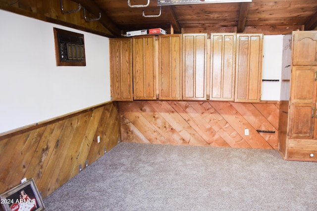 basement with carpet, wooden ceiling, and wooden walls