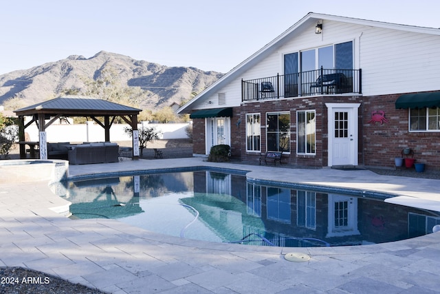 view of pool featuring a gazebo, a mountain view, an outdoor hangout area, and a patio