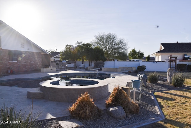 view of yard featuring a pool with hot tub and a patio