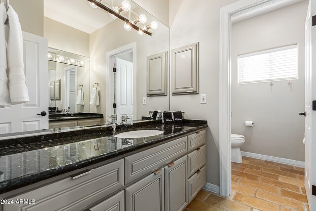 bathroom with toilet and vanity