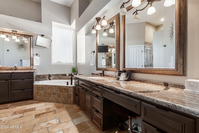 bathroom featuring vanity and separate shower and tub