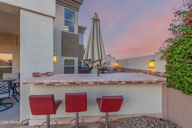 view of patio terrace at dusk