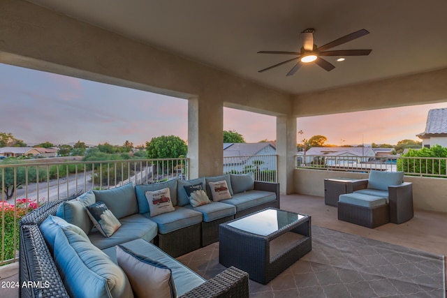 patio terrace at dusk with ceiling fan and an outdoor hangout area