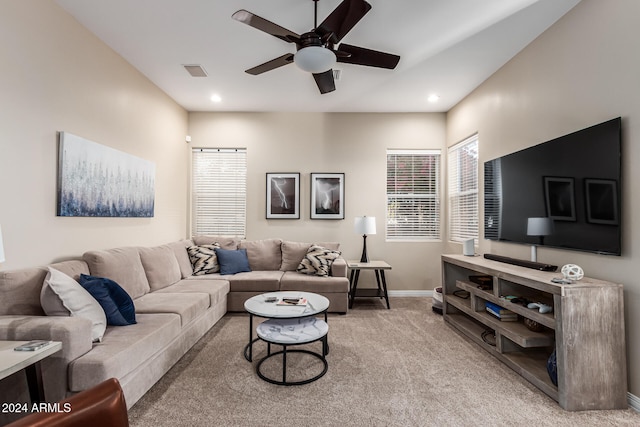 living room with ceiling fan and carpet