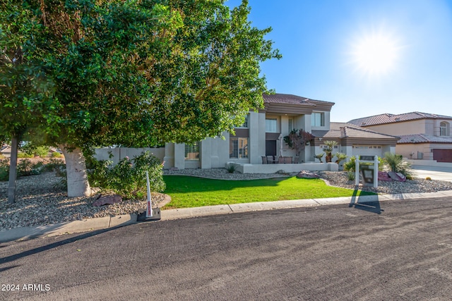 view of front facade with a front lawn and a garage