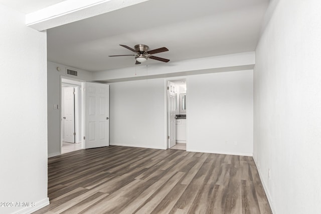 spare room with ceiling fan, wood finished floors, and baseboards