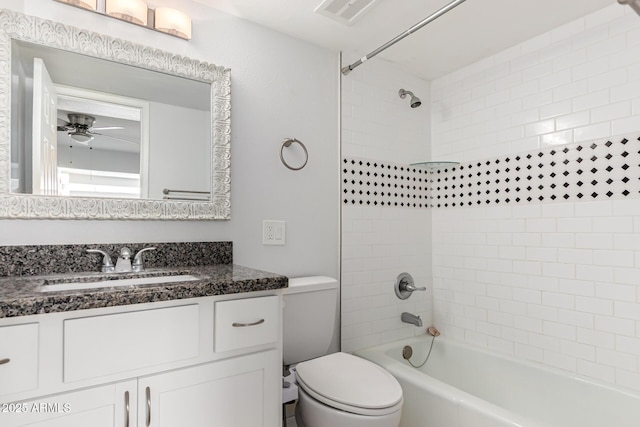 bathroom with washtub / shower combination, toilet, vanity, and ceiling fan
