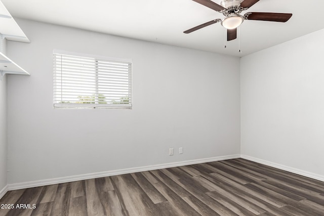 spare room featuring dark wood-type flooring, baseboards, and a ceiling fan