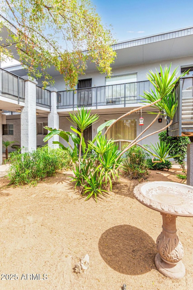 view of yard with a balcony