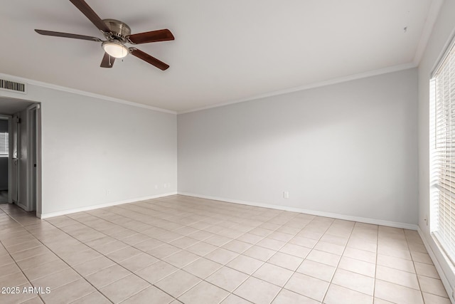 spare room with ceiling fan, crown molding, light tile patterned floors, plenty of natural light, and baseboards