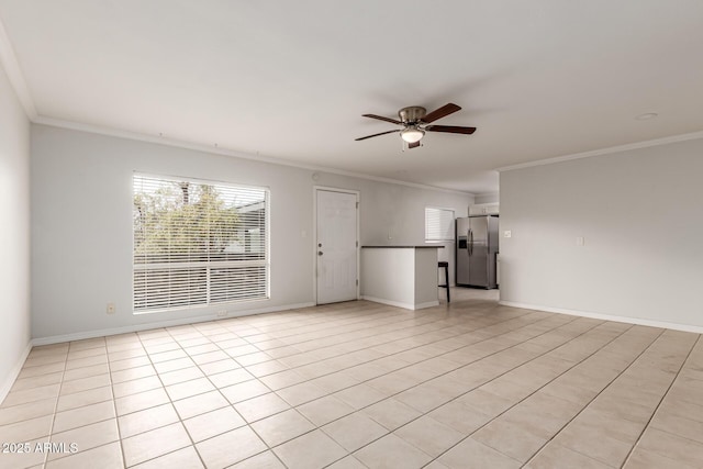 unfurnished living room featuring a ceiling fan, ornamental molding, baseboards, and light tile patterned flooring