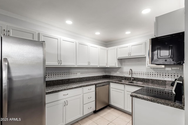 kitchen featuring appliances with stainless steel finishes, a sink, backsplash, light tile patterned floors, and crown molding