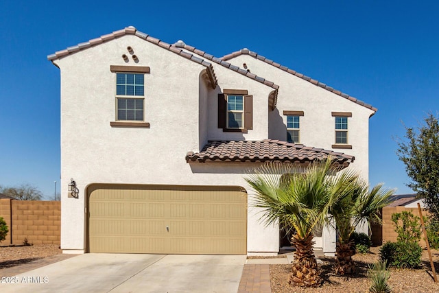 mediterranean / spanish home featuring a garage, driveway, fence, and stucco siding