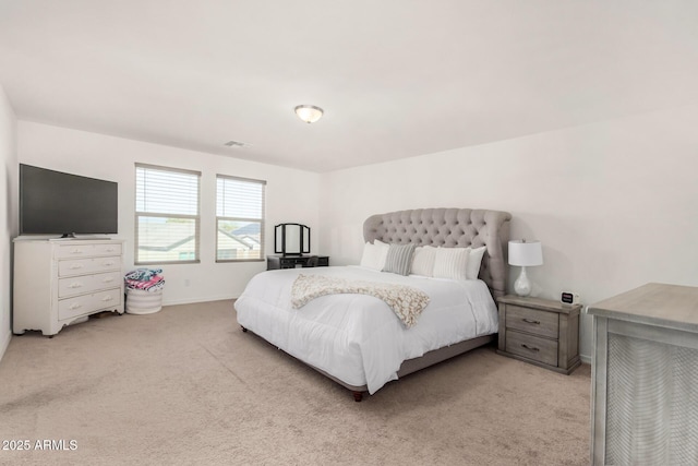 bedroom featuring visible vents, baseboards, and light colored carpet