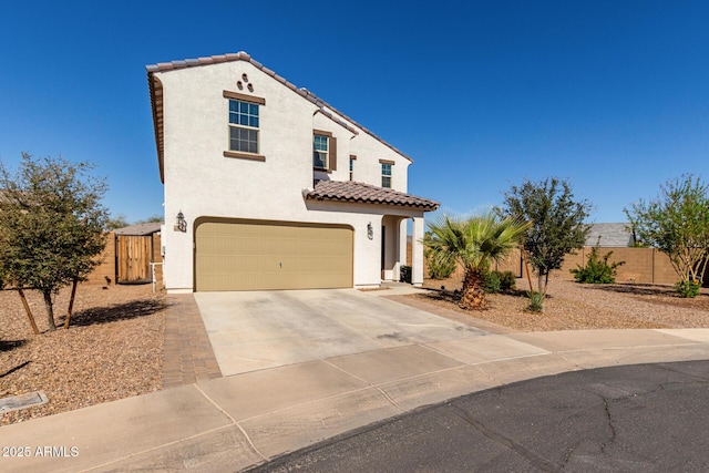 mediterranean / spanish home featuring fence, driveway, an attached garage, and stucco siding