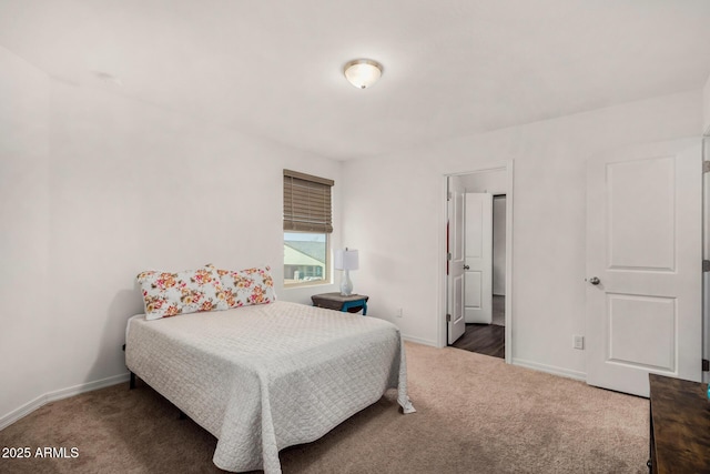 carpeted bedroom featuring baseboards