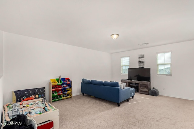 recreation room featuring carpet, visible vents, and baseboards