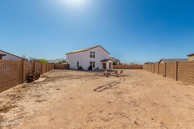 view of yard with a fenced backyard and a fire pit