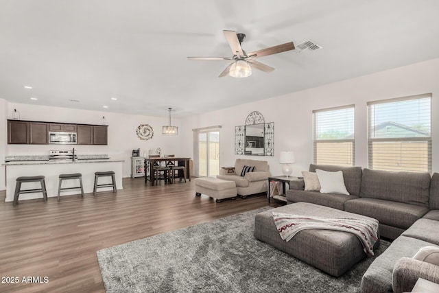 living area featuring dark wood-style floors, visible vents, a ceiling fan, and recessed lighting