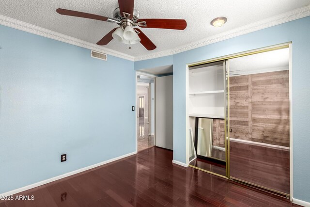 3135 W Echo Ln, Phoenix, AZ 85051 - unfurnished bedroom featuring a closet, crown molding, dark hardwood / wood-style floors, and a textured ceiling