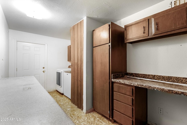 3135 W Echo Ln, Phoenix, AZ 85051 - kitchen with built in desk, a textured ceiling, and independent washer and dryer