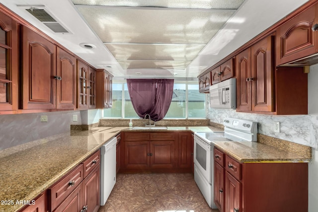 3135 W Echo Ln, Phoenix, AZ 85051 - kitchen featuring light stone countertops, sink, backsplash, and white appliances