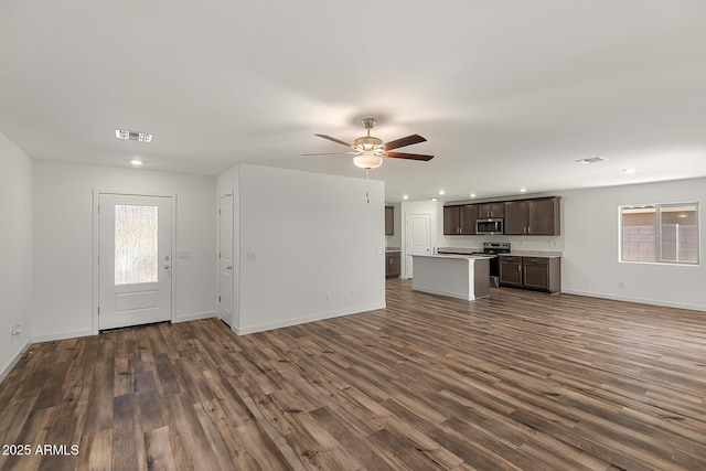 4051 N Ghost Hollow Way, Casa Grande, AZ 85122 - unfurnished living room featuring visible vents, dark wood-type flooring, and plenty of natural light
