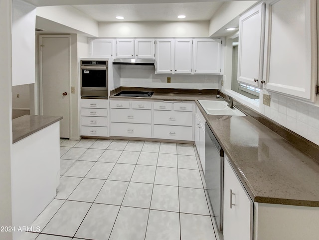 kitchen with dark stone countertops, sink, white cabinetry, and stainless steel appliances