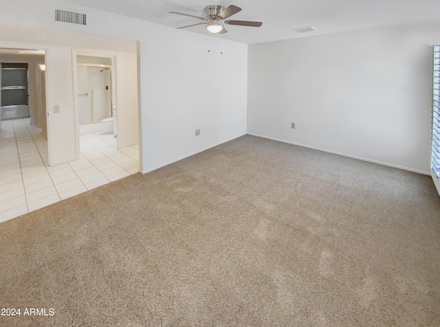 tiled empty room with ceiling fan