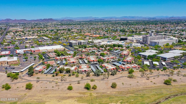 birds eye view of property with a mountain view