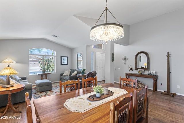 10333 E Gold Nugget Ct, Gold Canyon, AZ 85118 - dining room with a chandelier, wood finished floors, lofted ceiling, and baseboards