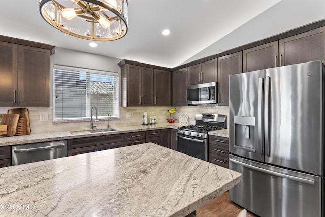 10333 E Gold Nugget Ct, Gold Canyon, AZ 85118 - kitchen with stainless steel appliances, a sink, dark brown cabinetry, recessed lighting, and vaulted ceiling