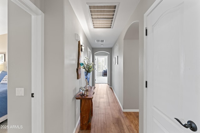 10333 E Gold Nugget Ct, Gold Canyon, AZ 85118 - hall featuring arched walkways, wood finished floors, and baseboards
