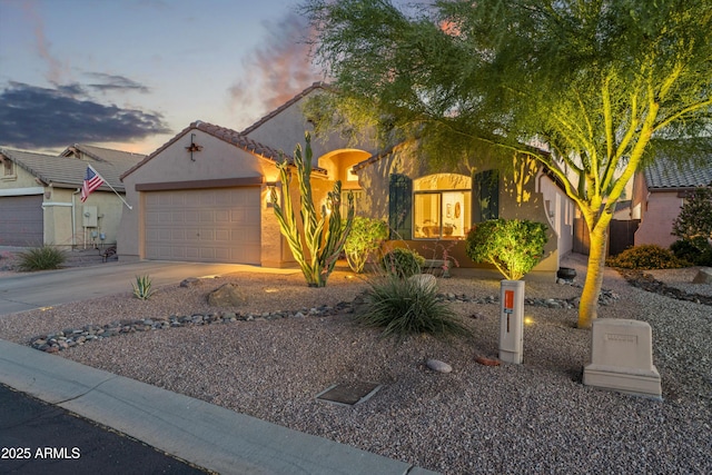 10333 E Gold Nugget Ct, Gold Canyon, AZ 85118 - view of front of house featuring an attached garage, stucco siding, and concrete driveway