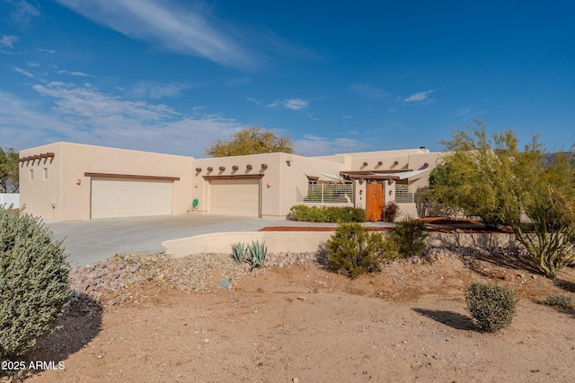 pueblo-style house with a garage