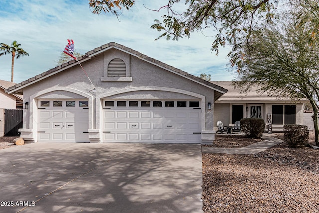 ranch-style house featuring driveway, an attached garage, and stucco siding