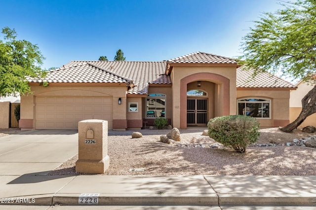 2226 N Gentry, Mesa, AZ 85213 - mediterranean / spanish home with stucco siding, concrete driveway, and a garage