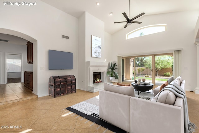 2226 N Gentry, Mesa, AZ 85213 - living area featuring a ceiling fan, high vaulted ceiling, light tile patterned floors, arched walkways, and healthy amount of natural light