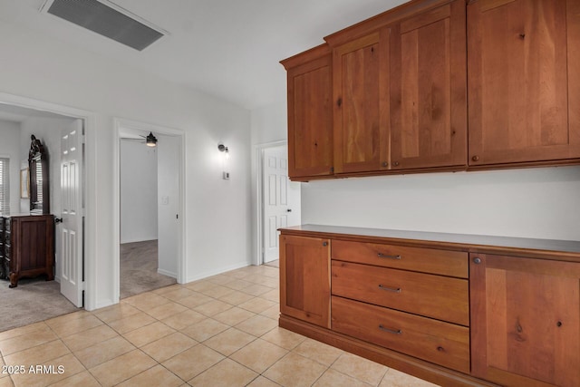 2226 N Gentry, Mesa, AZ 85213 - kitchen featuring brown cabinetry, light colored carpet, light tile patterned floors, and ceiling fan