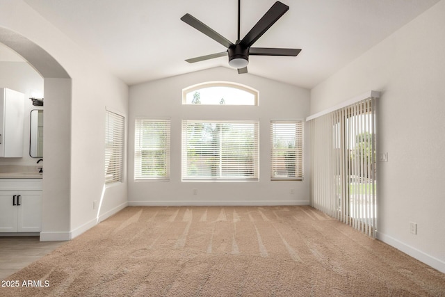2226 N Gentry, Mesa, AZ 85213 - empty room featuring a ceiling fan, arched walkways, baseboards, vaulted ceiling, and light colored carpet