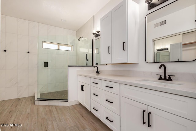 2226 N Gentry, Mesa, AZ 85213 - bathroom with a walk in shower, double vanity, and wood finished floors