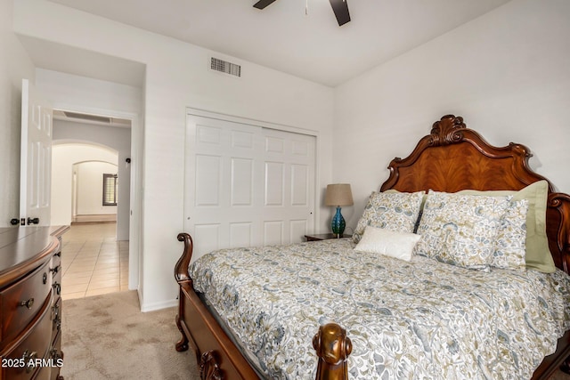 2226 N Gentry, Mesa, AZ 85213 - bedroom with arched walkways, a closet, light carpet, light tile patterned floors, and baseboards